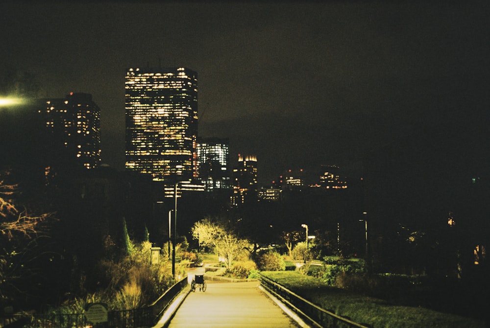 a city at night with a train track going down it