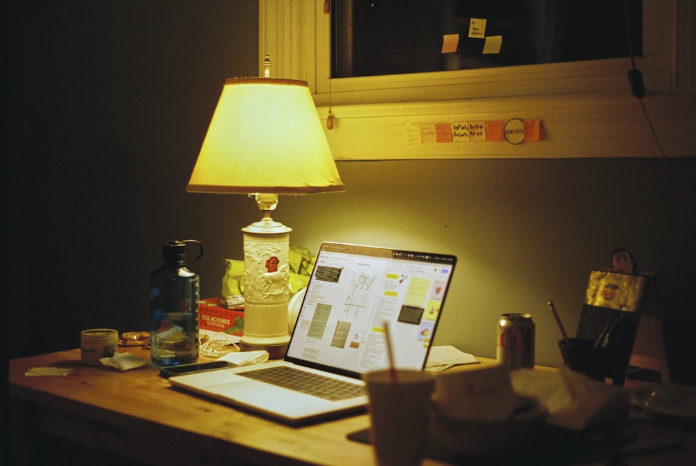 a laptop computer sitting on top of a wooden desk