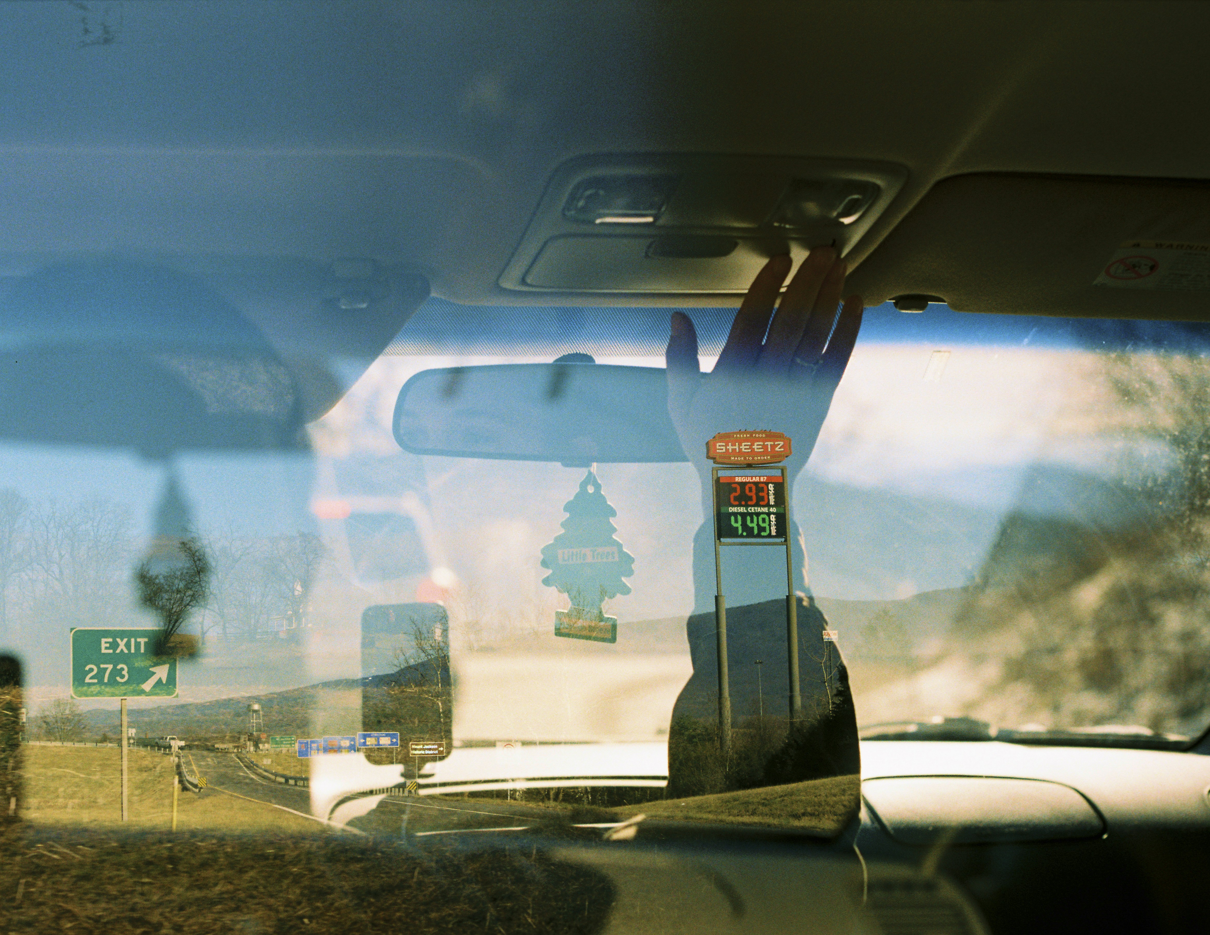 a reflection of a fire hydrant in the windshield of a car