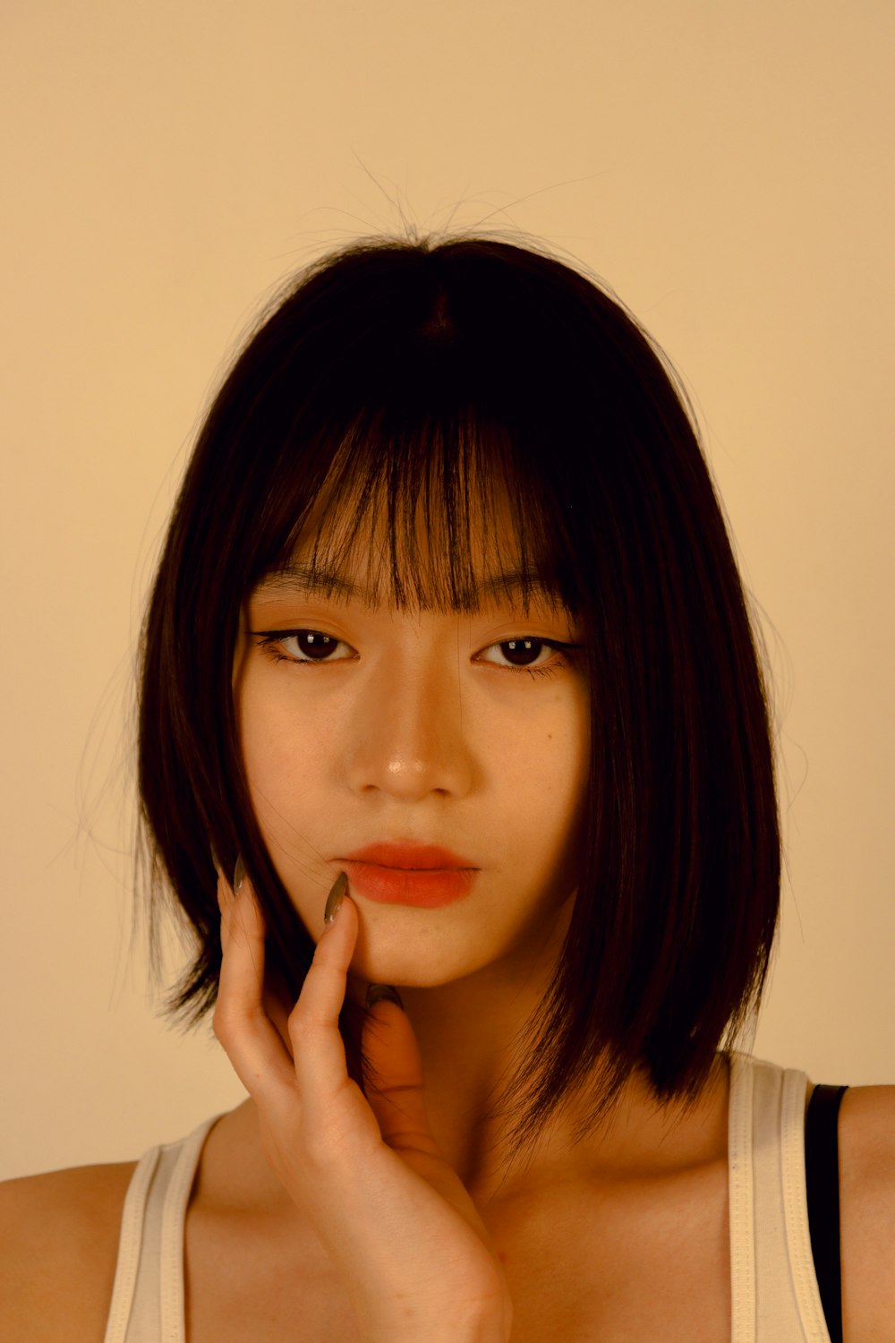 an asian woman with a short bob cut