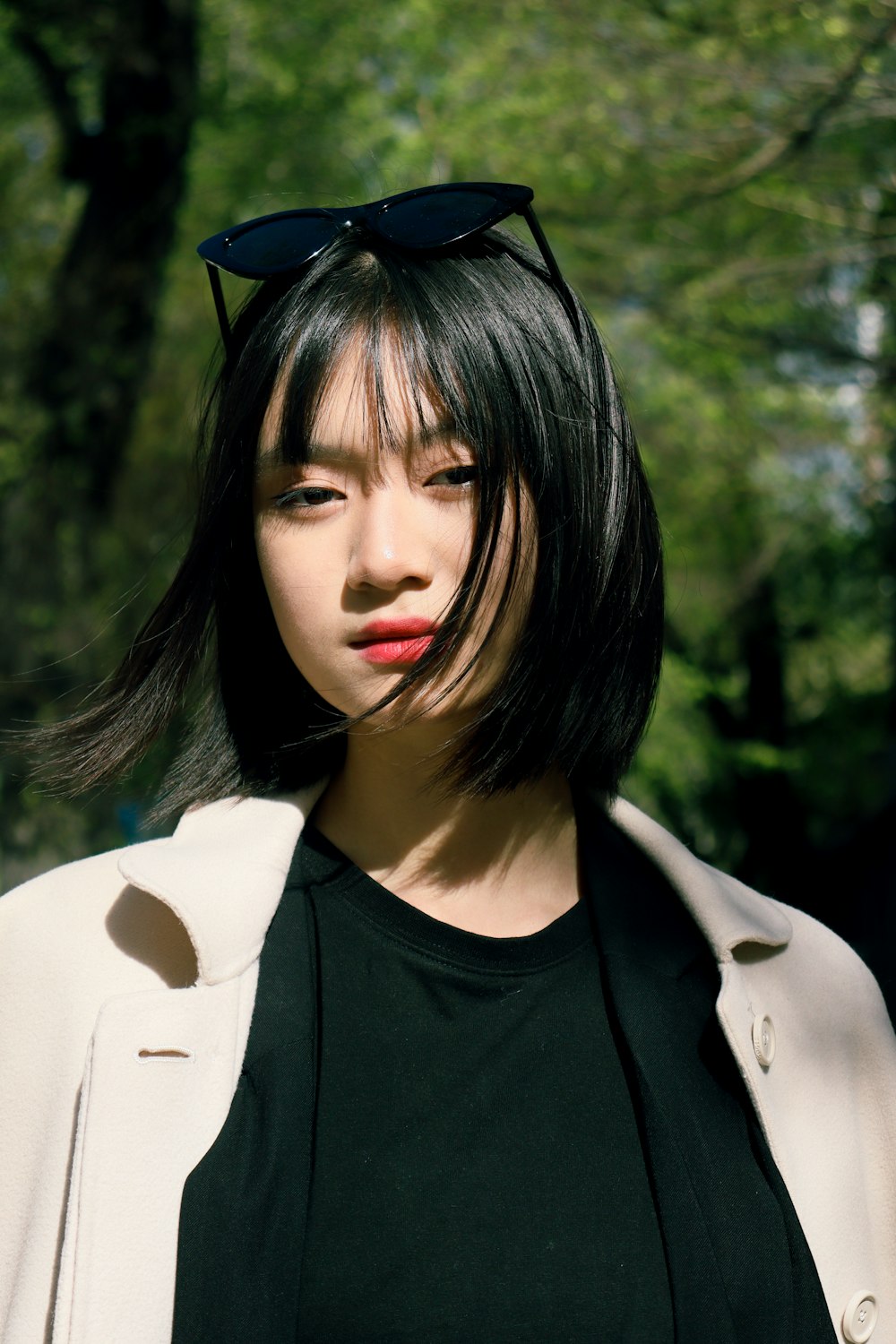 a woman wearing sunglasses and a black shirt