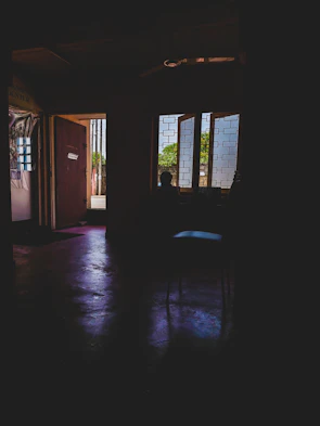 Wide shot of a partially framed room with natural light streaming through.