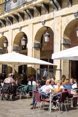 A group of happy students practicing Spanish in a sunlit café in Barcelona.