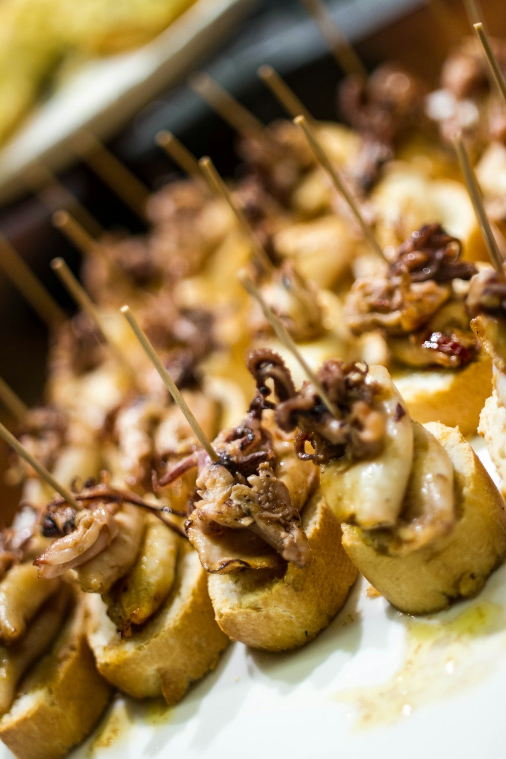 a close up of a plate of food with toothpicks