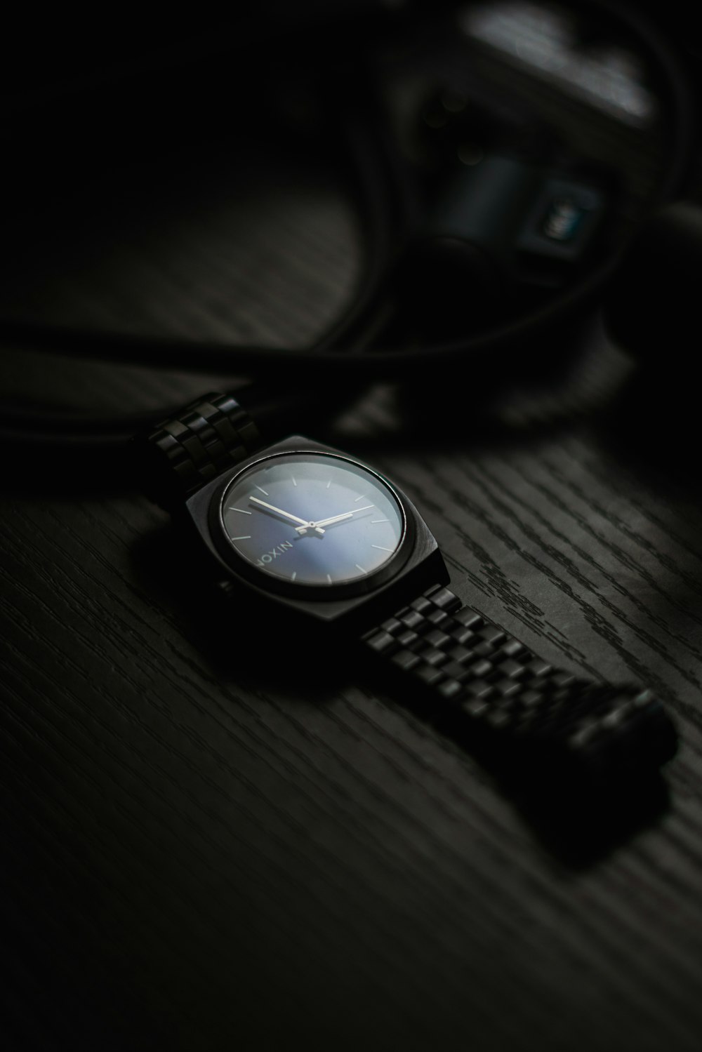 a watch sitting on top of a wooden table