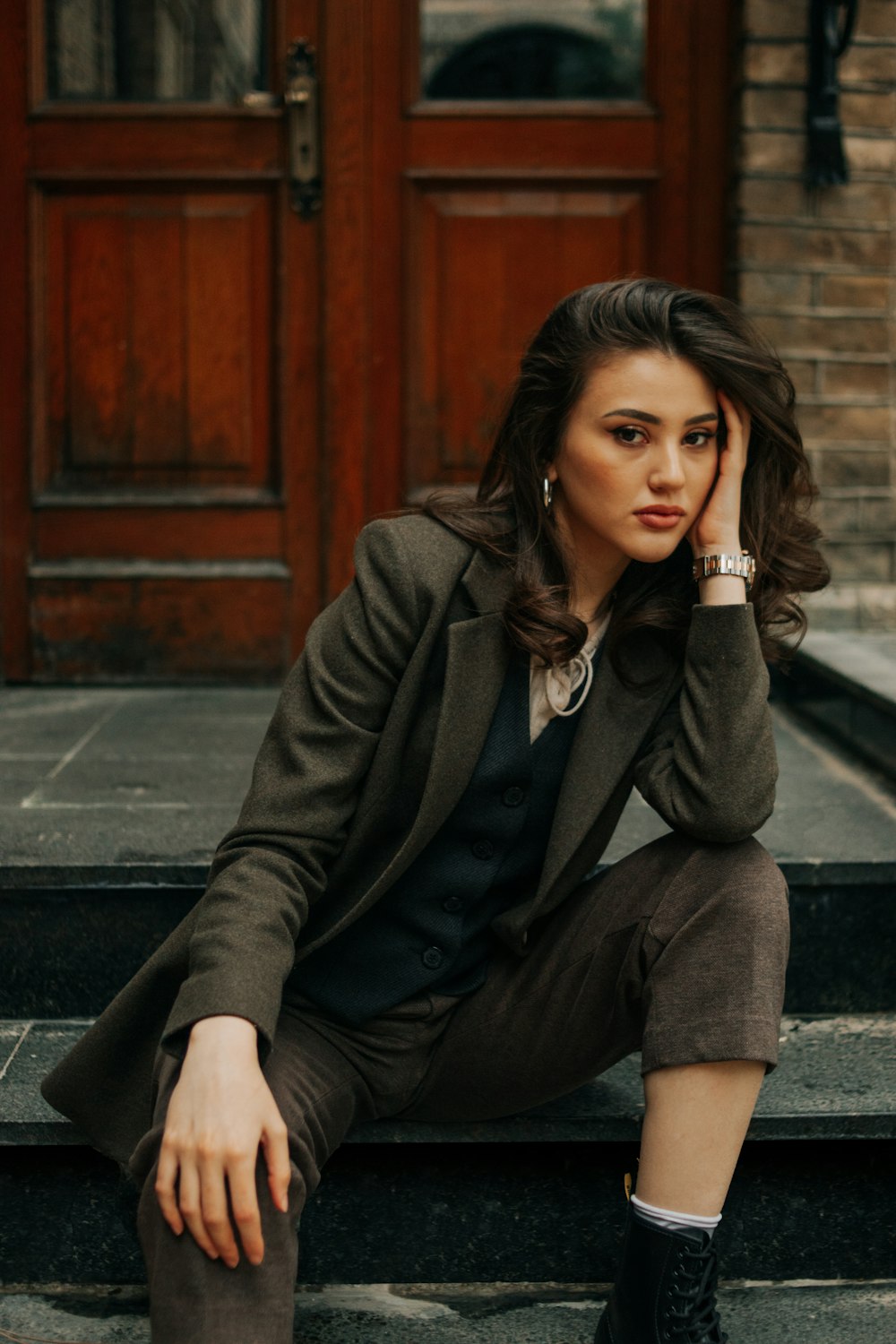 a woman sitting on the steps of a building