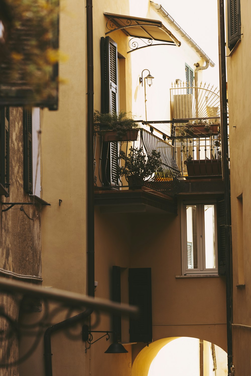 a building with a balcony and a yellow light in front of it