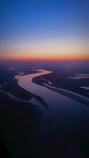 a river running through a lush green countryside