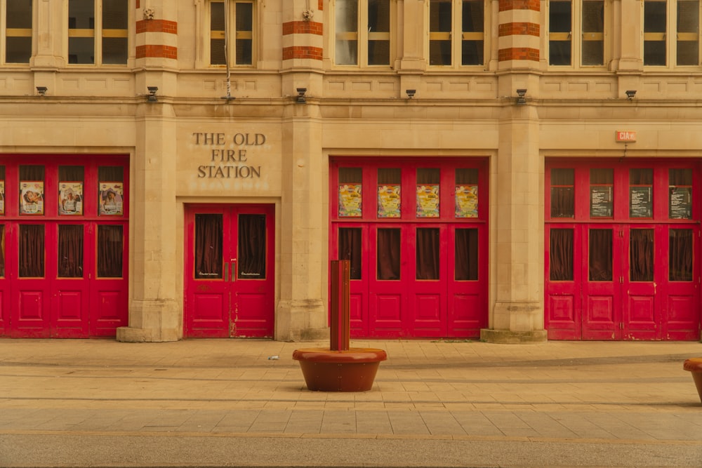 a couple of red doors sitting in front of a building