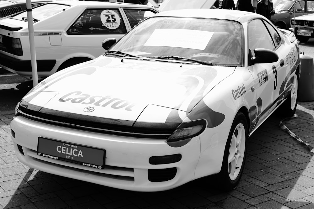 a white car parked on the side of a road