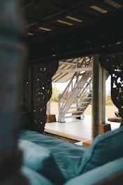 A cozy majlis area featuring deep blue velvet cushions and intricately carved wooden frames.