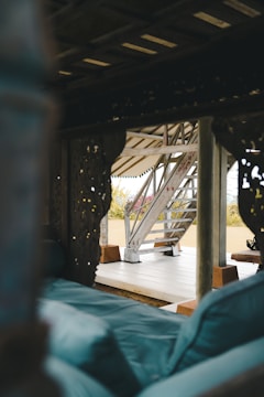 A cozy majlis area featuring deep blue velvet cushions and intricately carved wooden frames.