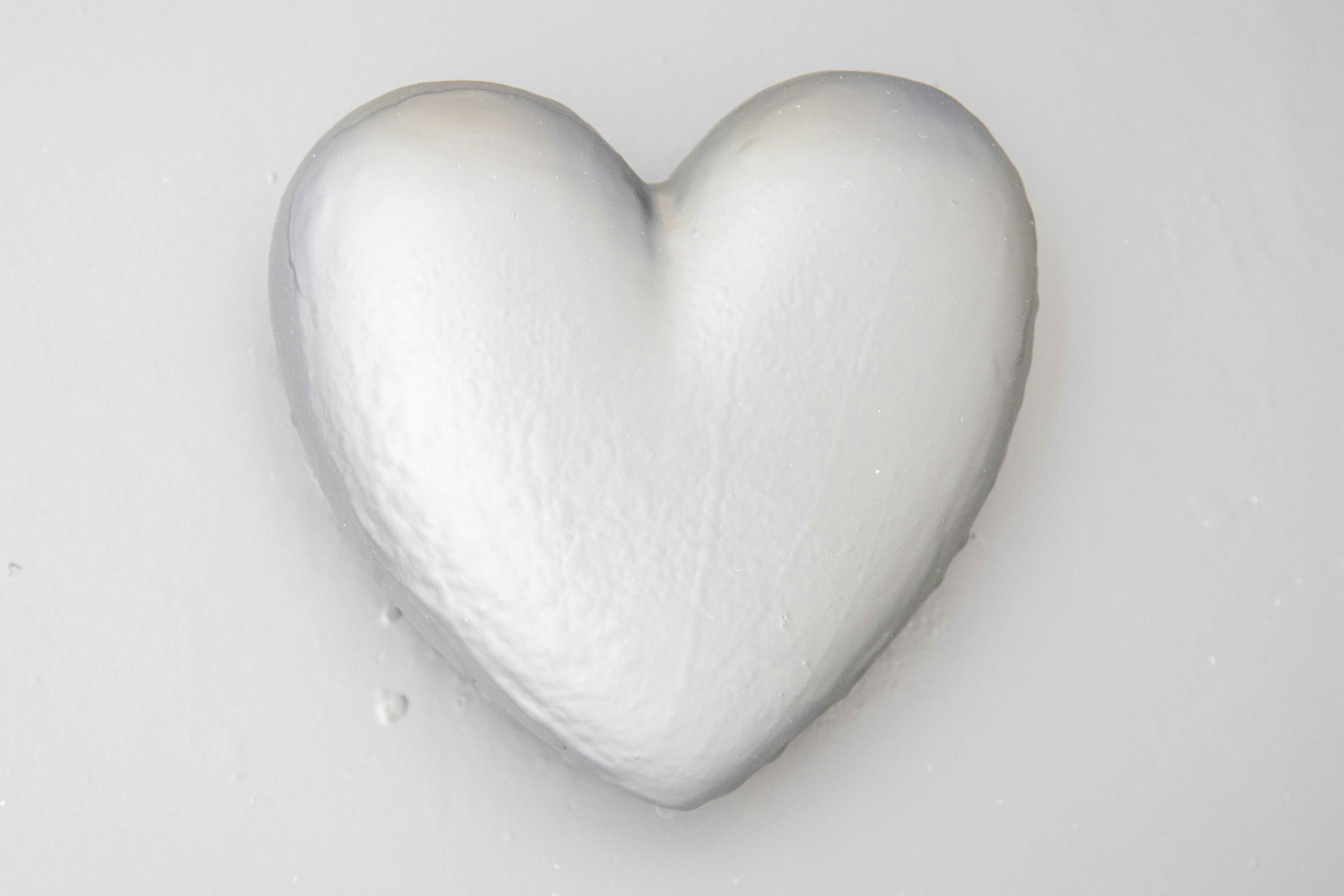a white heart shaped candy sitting on top of a table