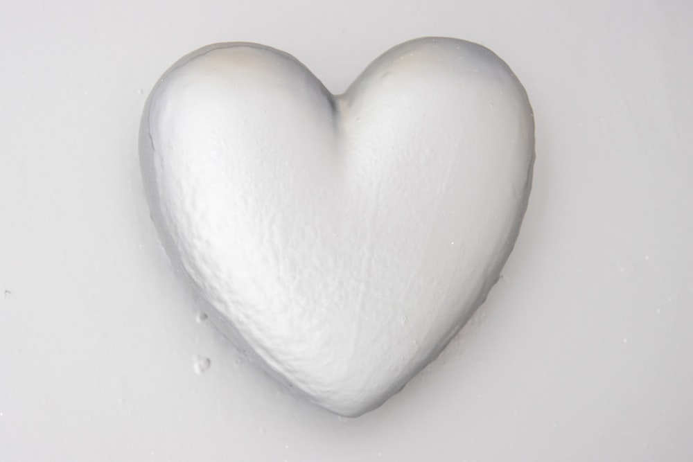 a white heart shaped candy sitting on top of a table