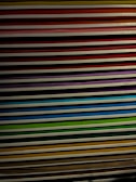 A stack of colorful printed coloring pages spread out on a table.
