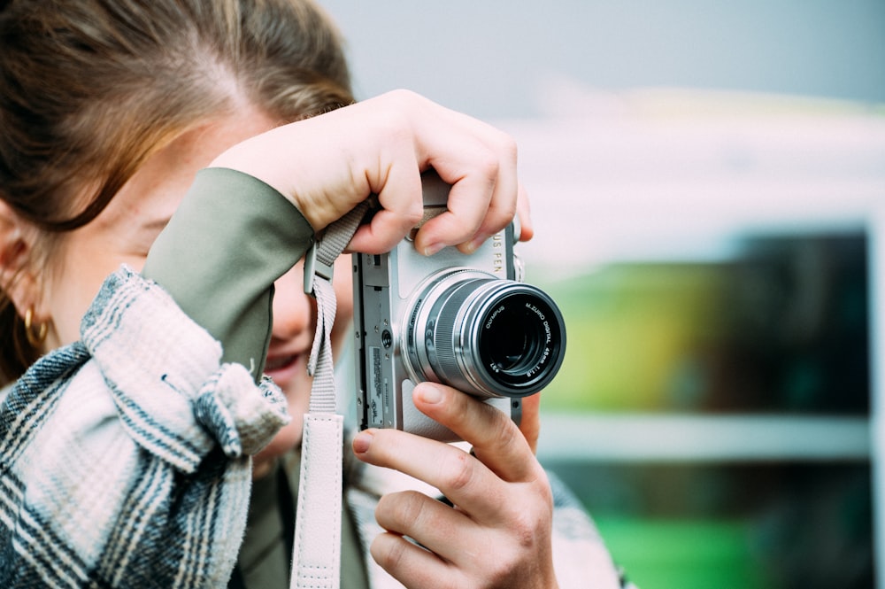 a woman taking a picture with a camera