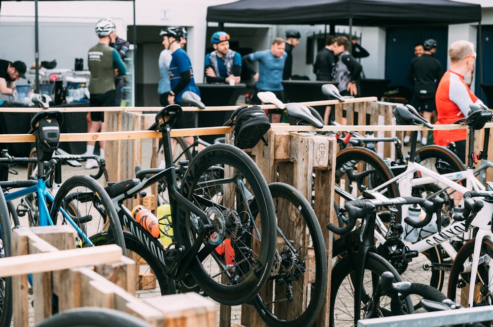 a group of people standing around a bunch of bikes