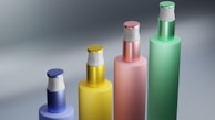 A selection of shiny metal and plastic perfume bottle pumps in different styles and colors.