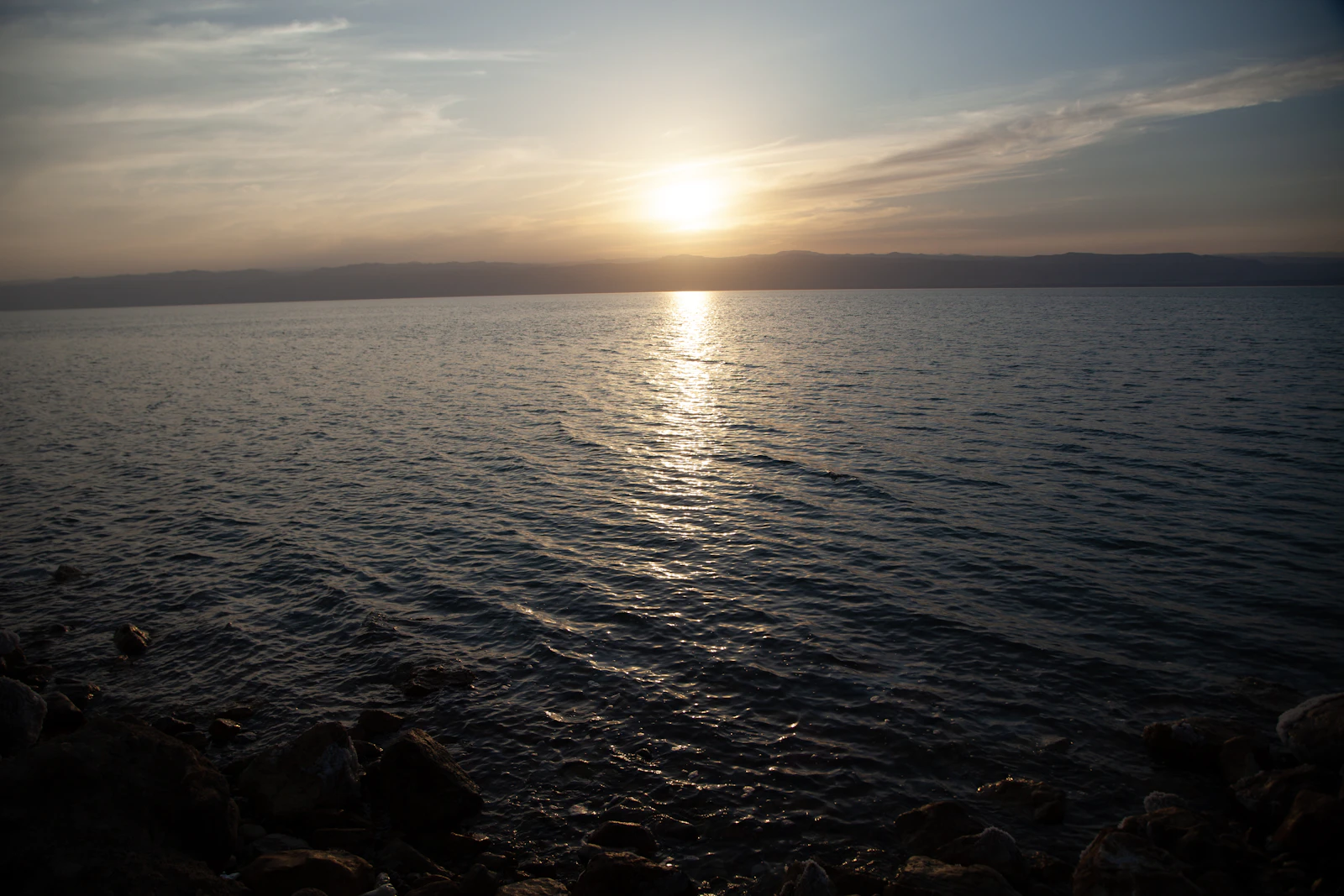 Sunset over the calm water of the Dead Sea