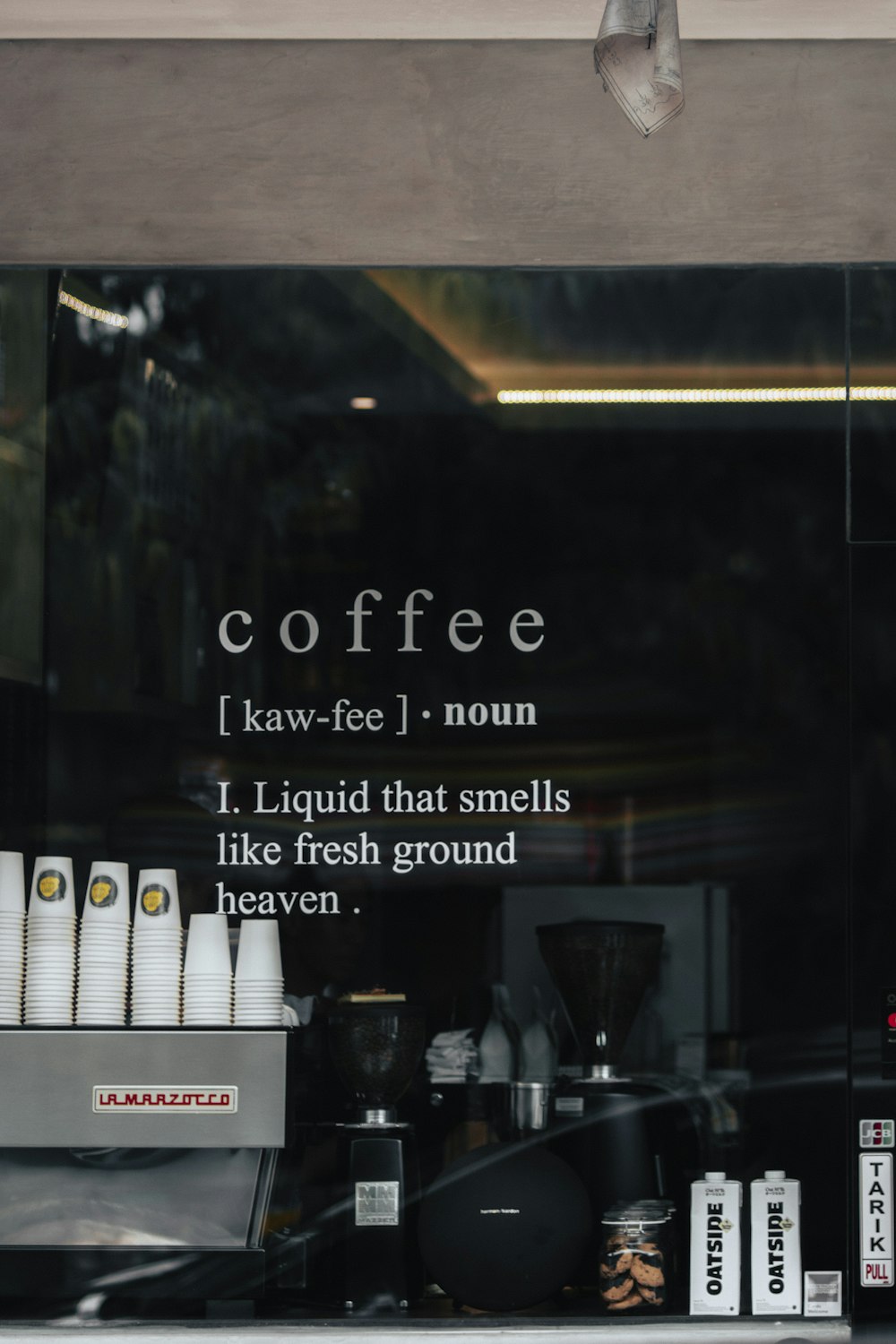 a coffee shop window with coffee cups on display