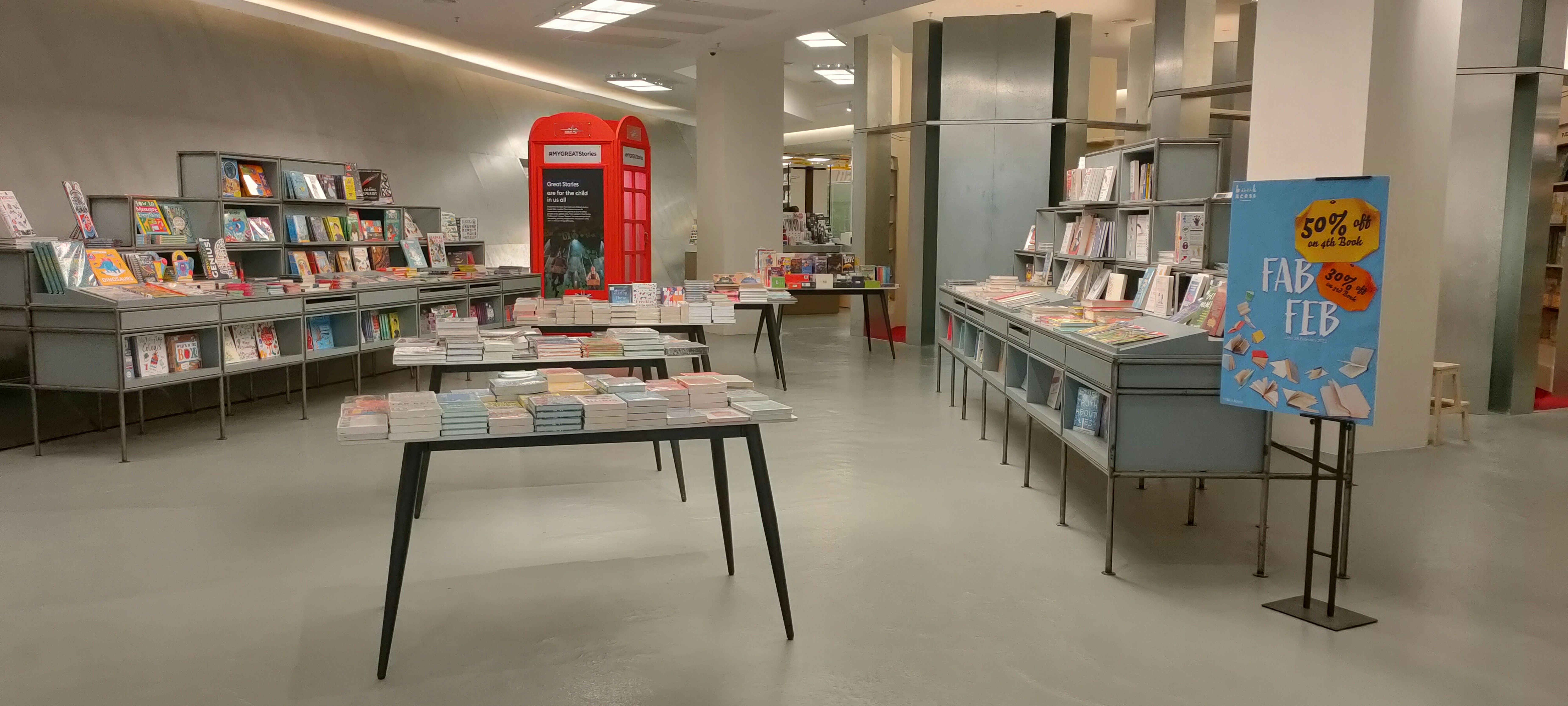 Books displayed on shelves in a modern bookstore