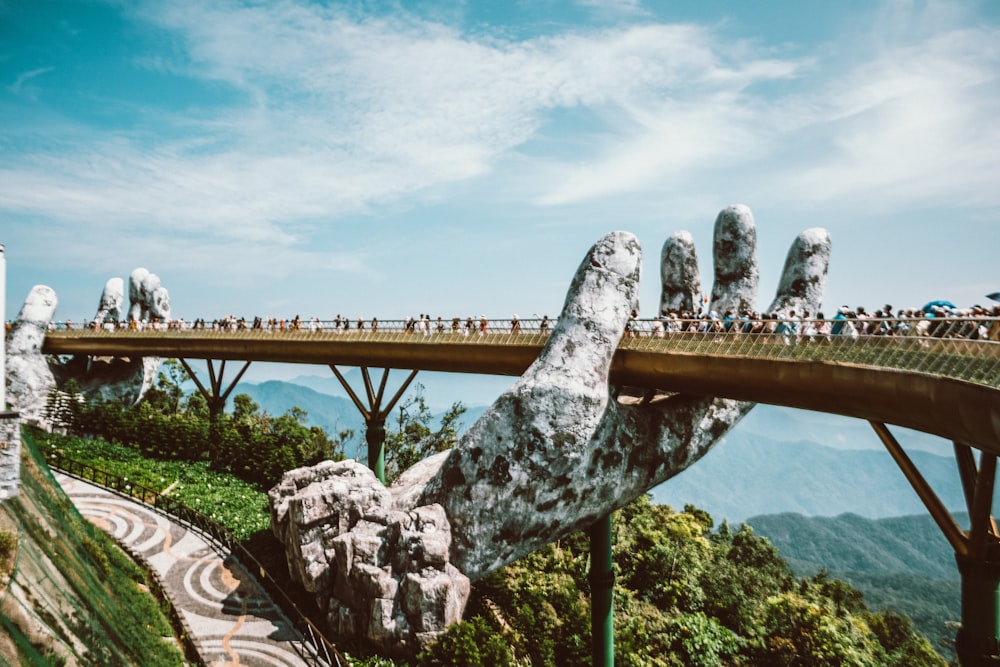 a bridge that has a giant hand on top of it