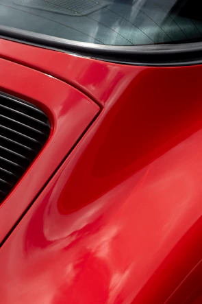 Side-by-side before and after images of a car’s exterior paint correction.