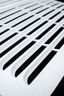 a close up of a vent on a white surface