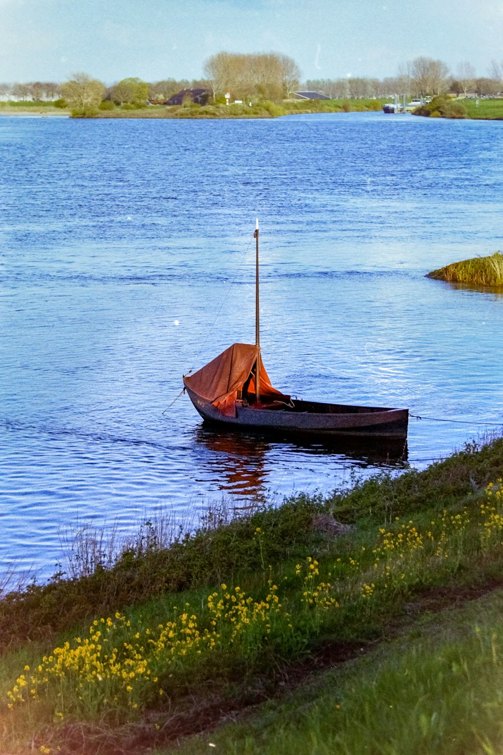 a small boat floating on top of a lake