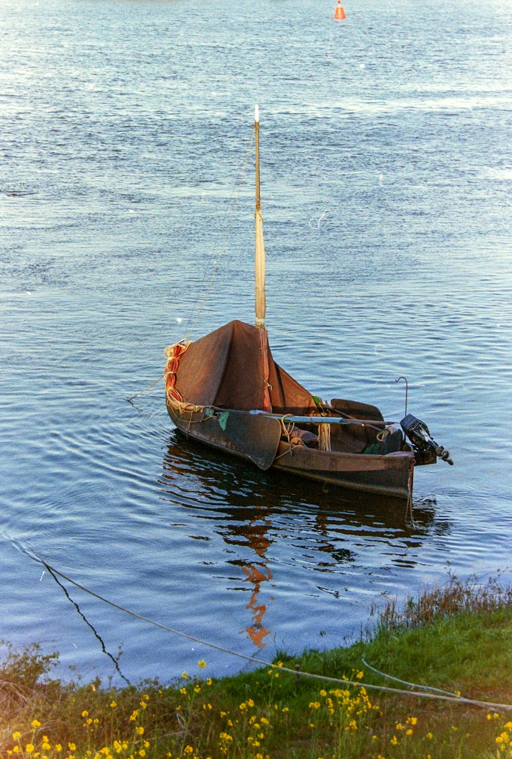 a small boat floating on top of a lake