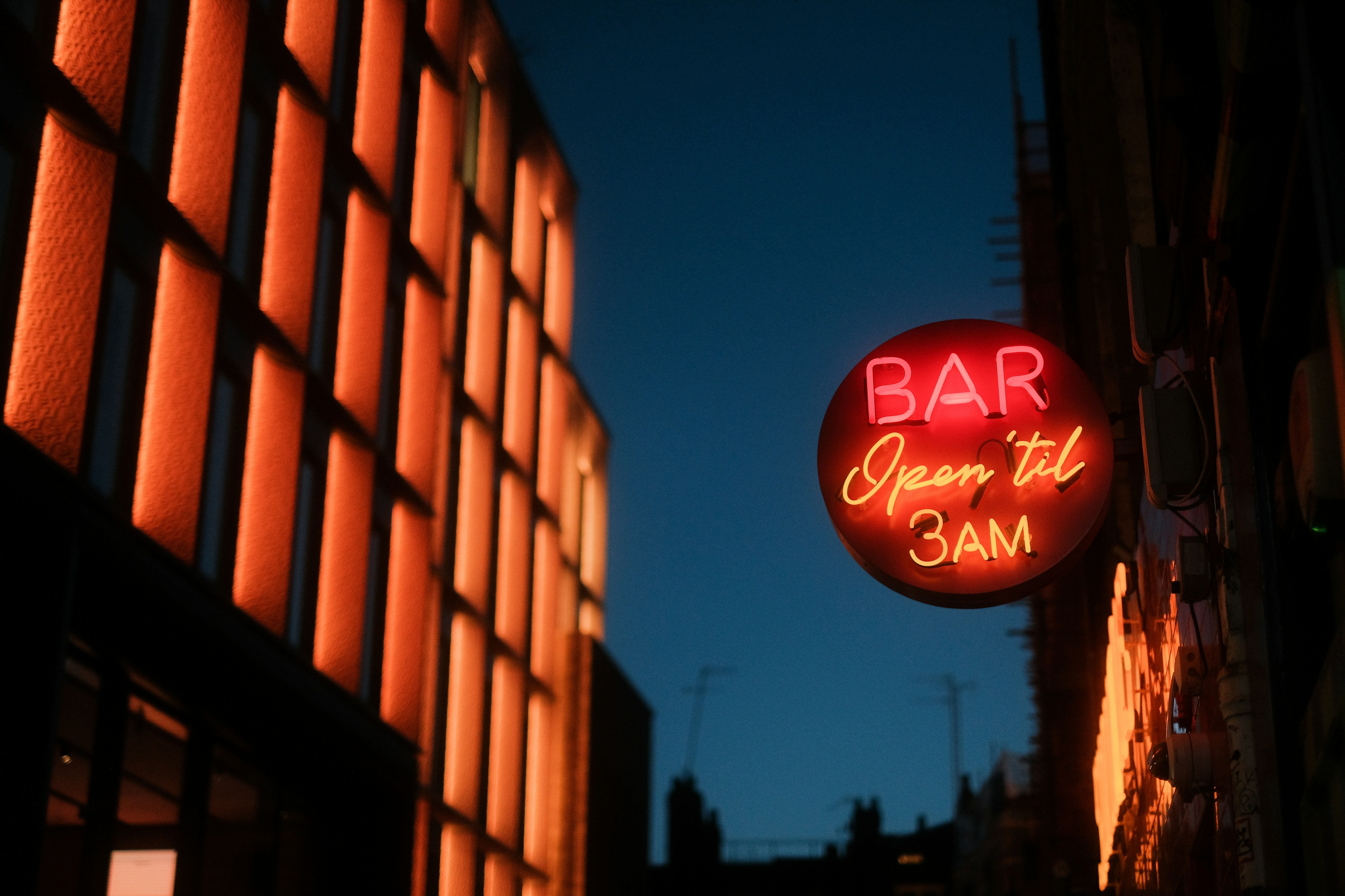 Neon BAR open til 3AM sign on a building
