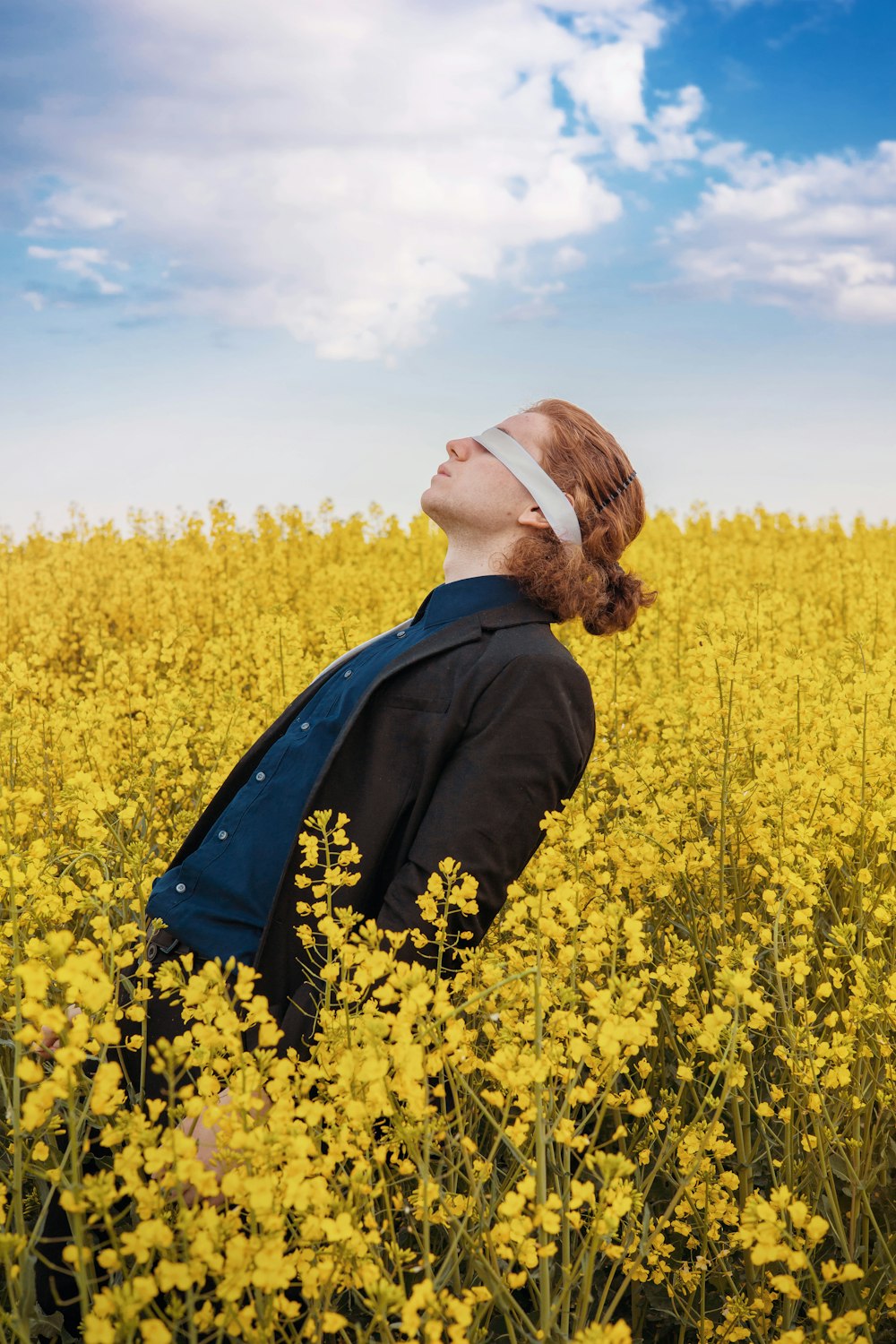 a woman standing in a field of yellow flowers