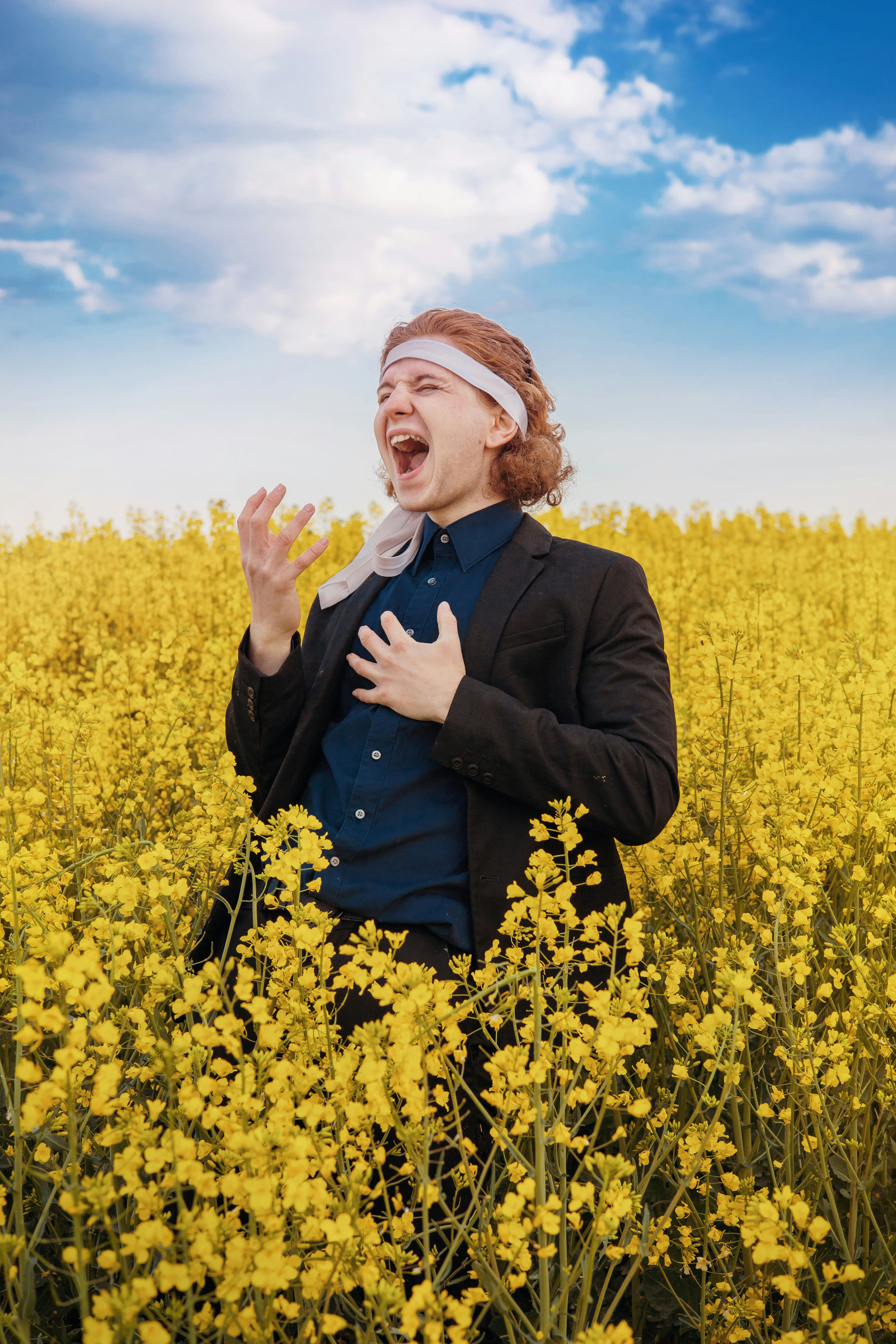 a woman standing in a field of yellow flowers
