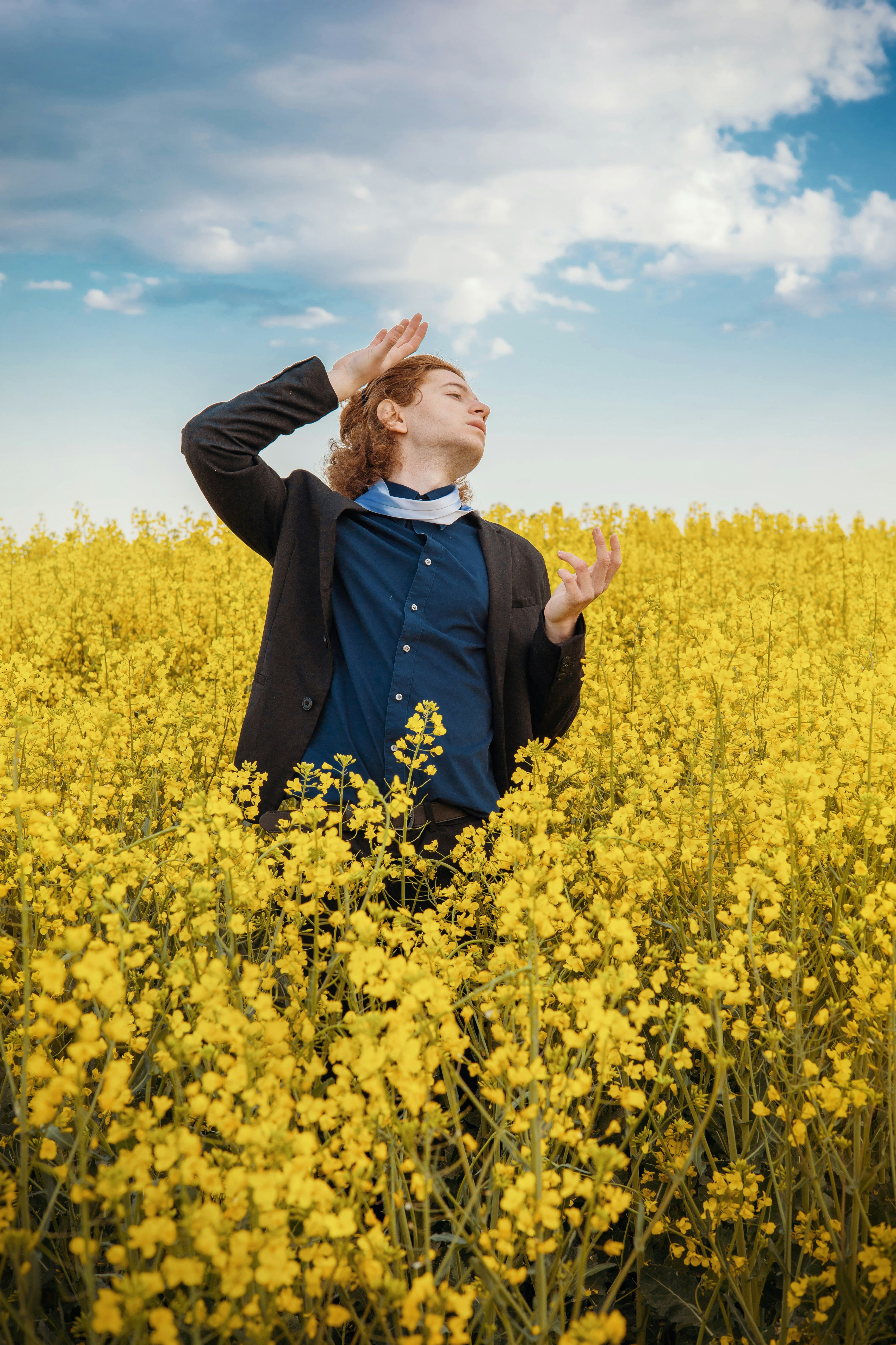 a woman standing in a field of yellow flowers