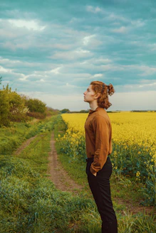 a woman standing in the middle of a field