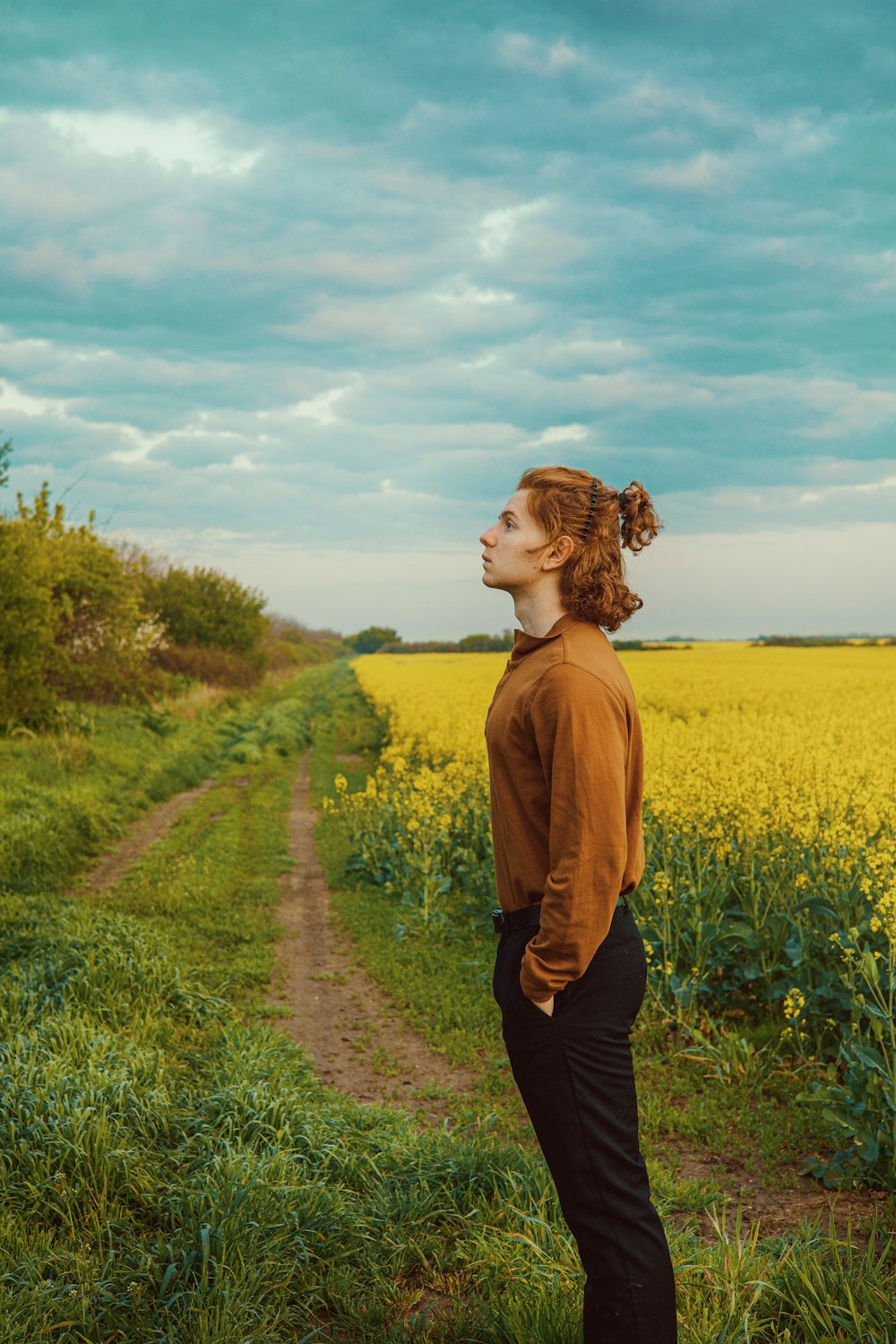 a woman standing in the middle of a field