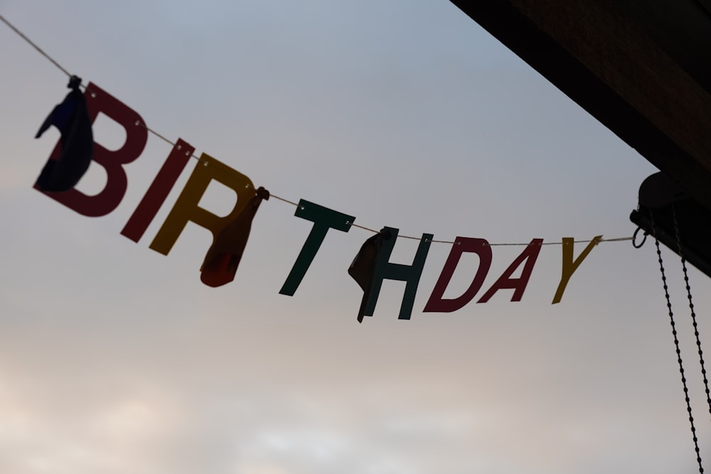 a birthday banner hanging from a clothes line