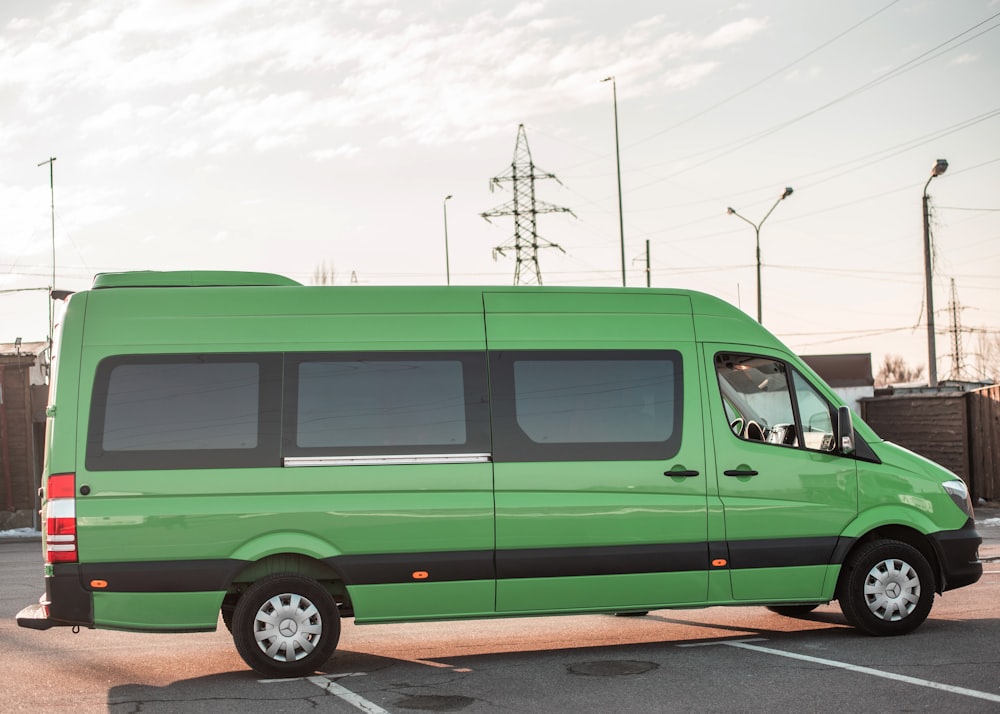 a green van parked in a parking lot