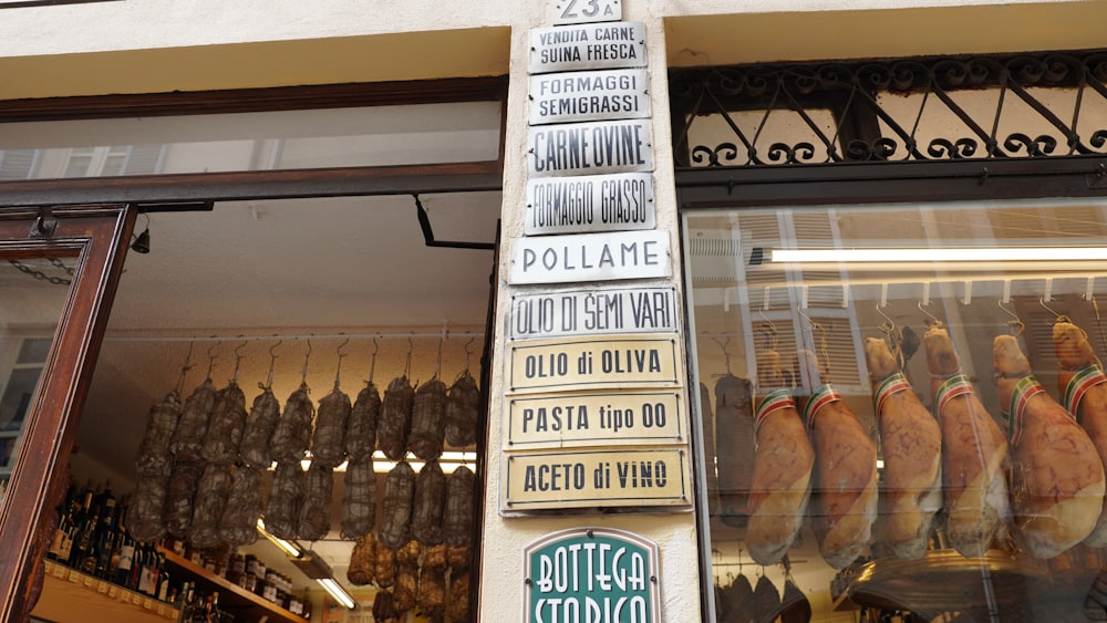 a street sign in front of a store window