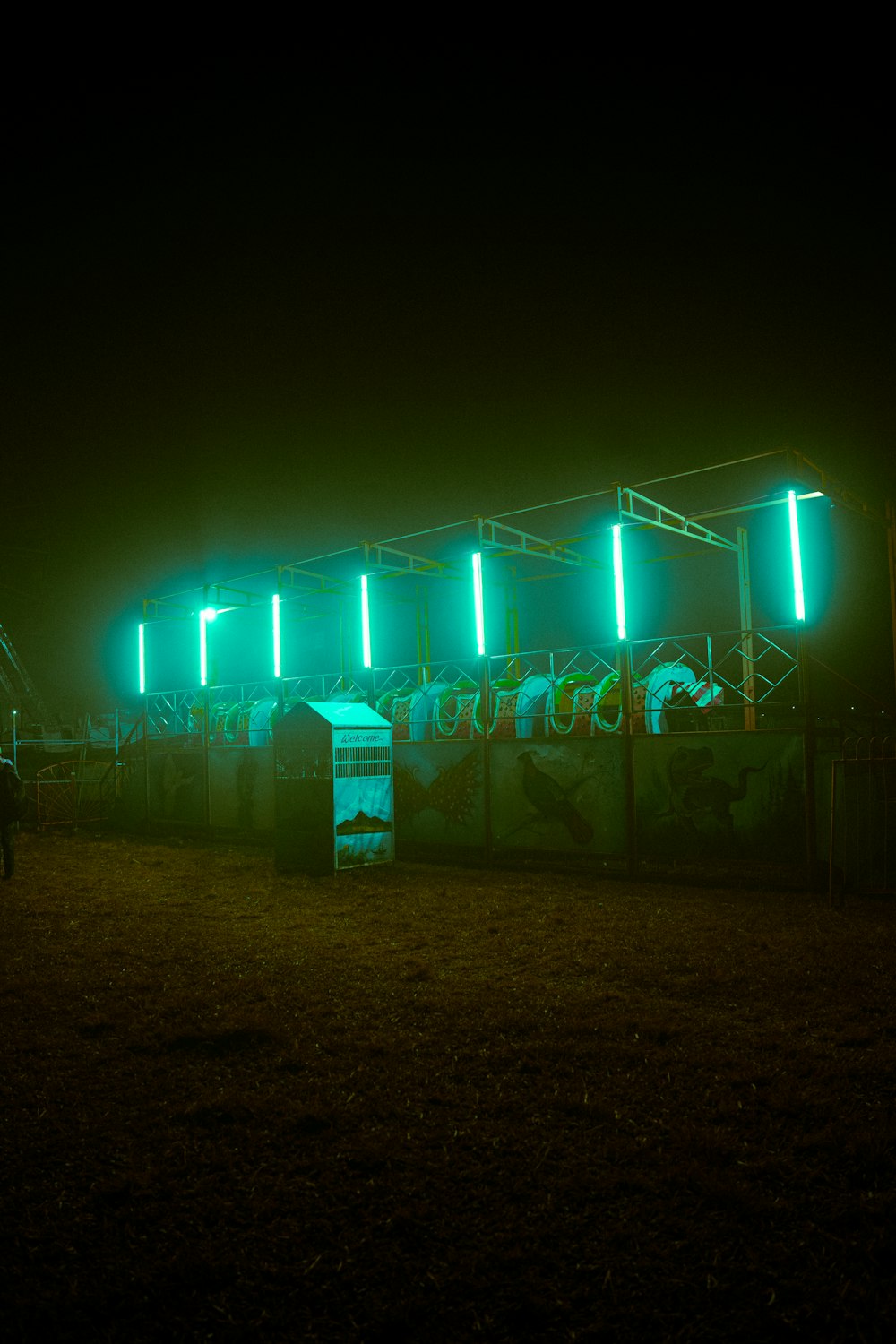 a group of people standing in front of a green light