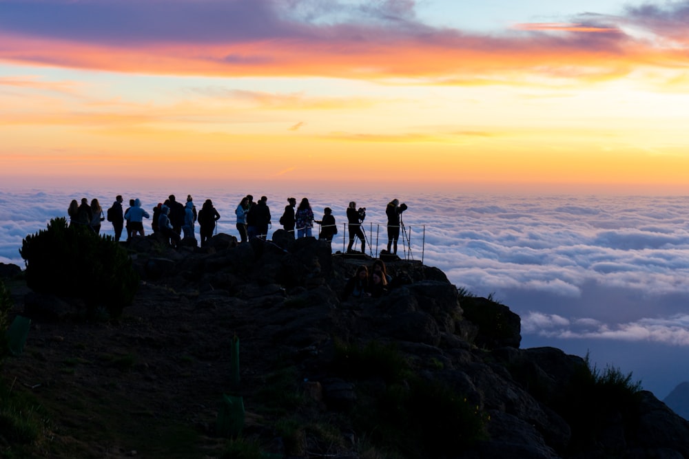 a group of people standing on top of a mountain