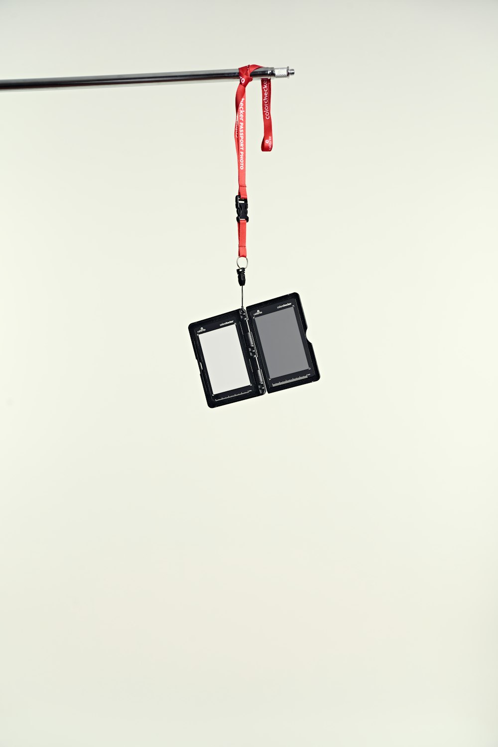 a pair of small cameras hanging from a wire