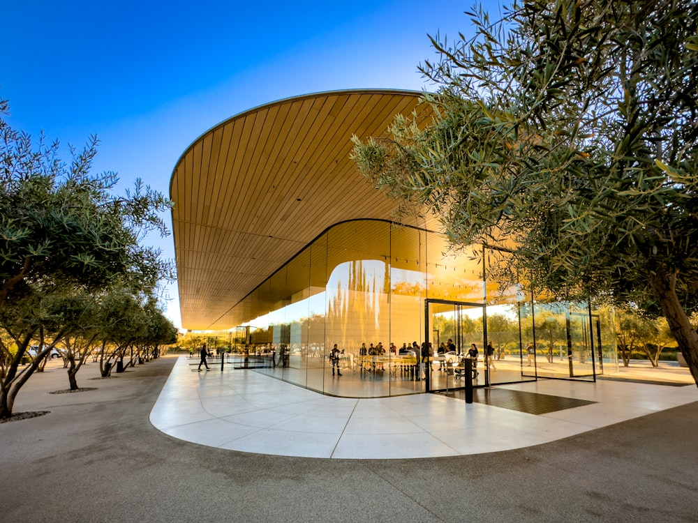 a building with a circular entrance and trees in front of it