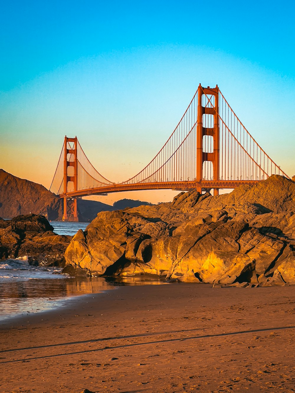 a view of the golden gate bridge from the beach