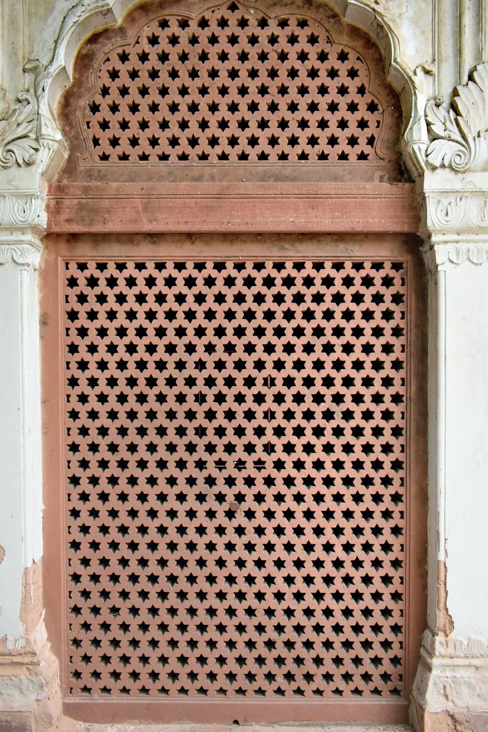 a close up of a metal grate on a wall