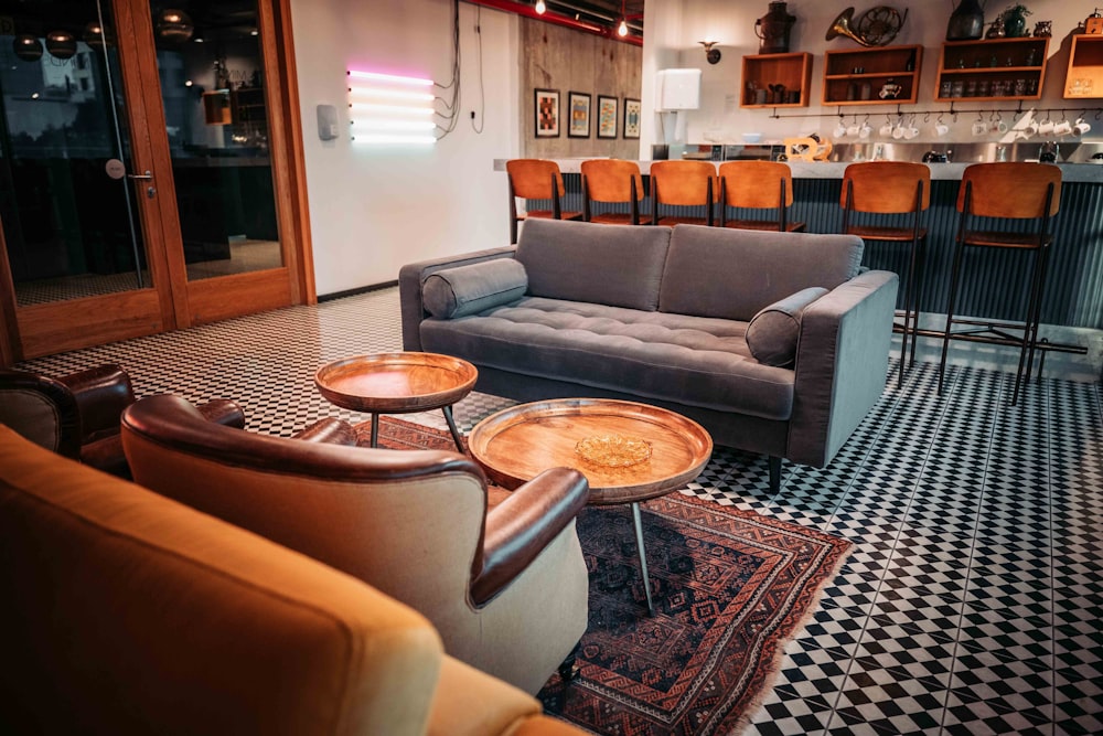 a living room filled with furniture and a checkered floor