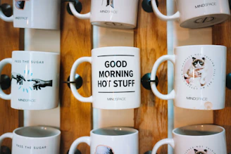 Colorful mugs featuring comical social commentary sitting on a kitchen counter.