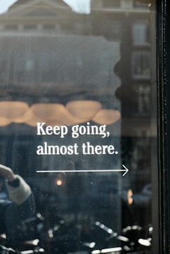 a window with a sign that says keep going, almost there