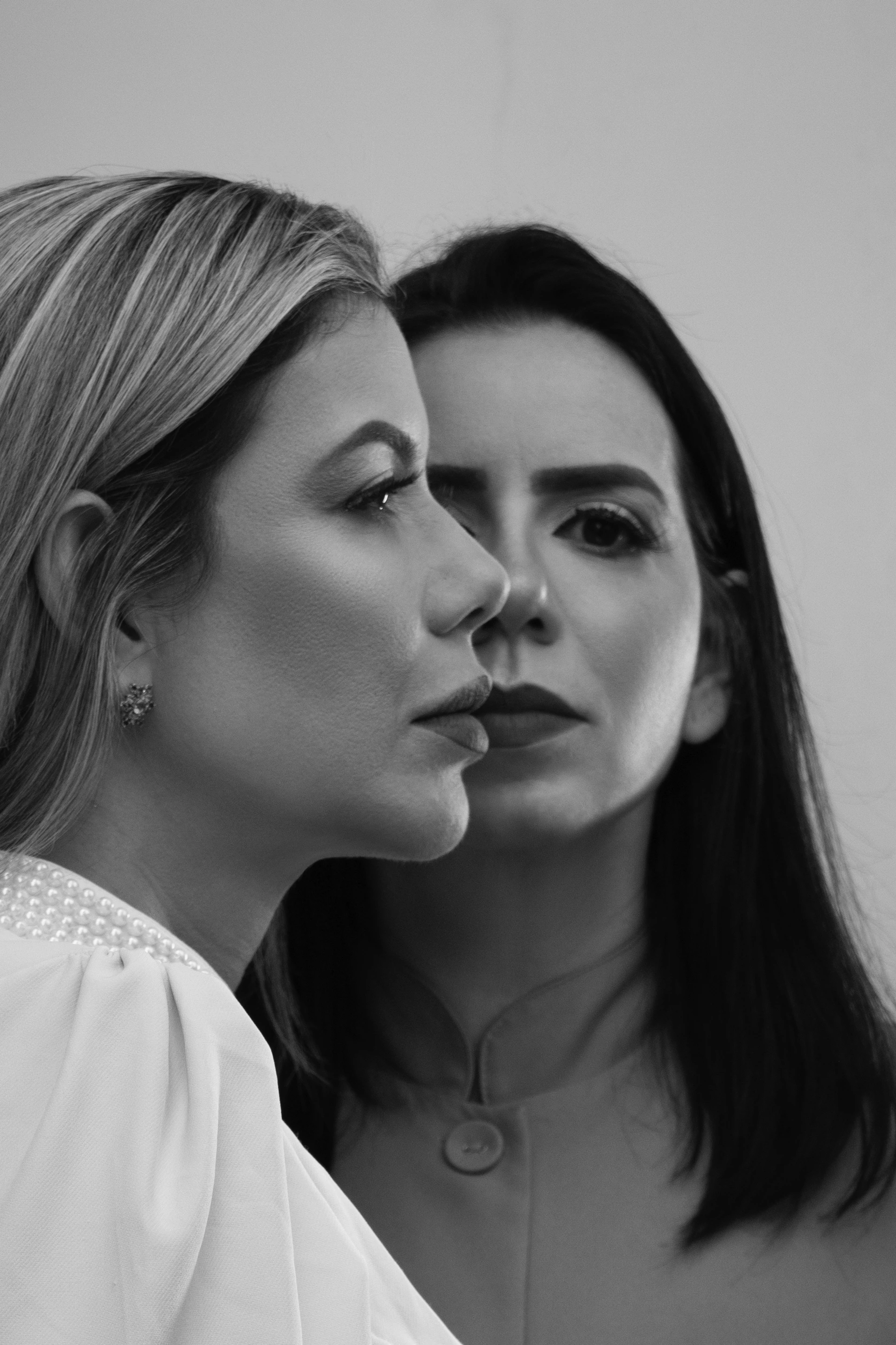 two beautiful women standing next to each other
