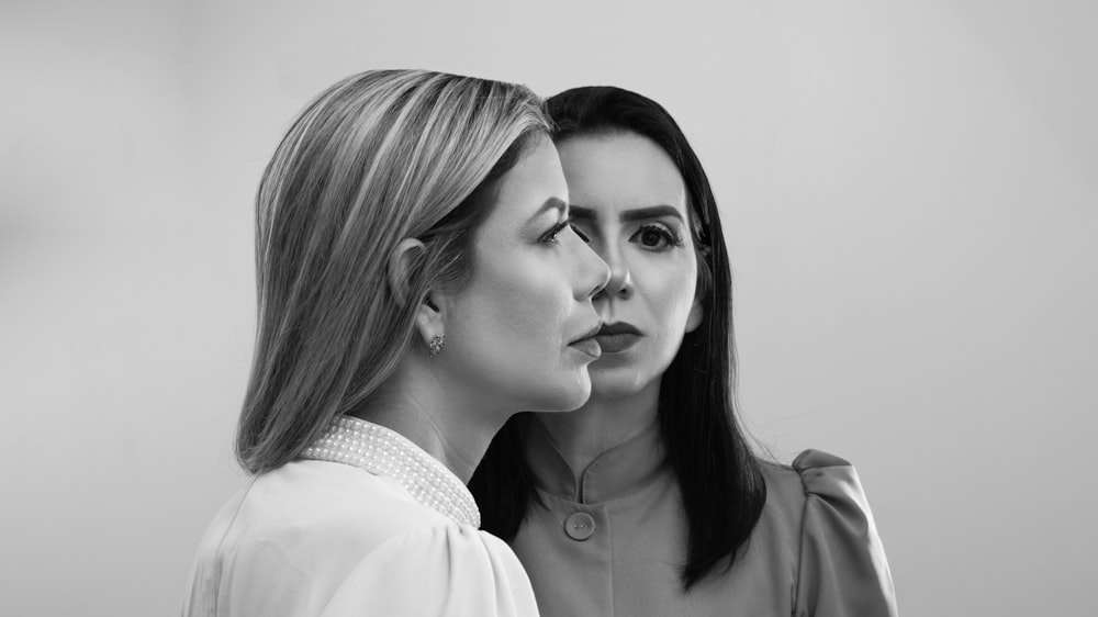 a black and white photo of two women